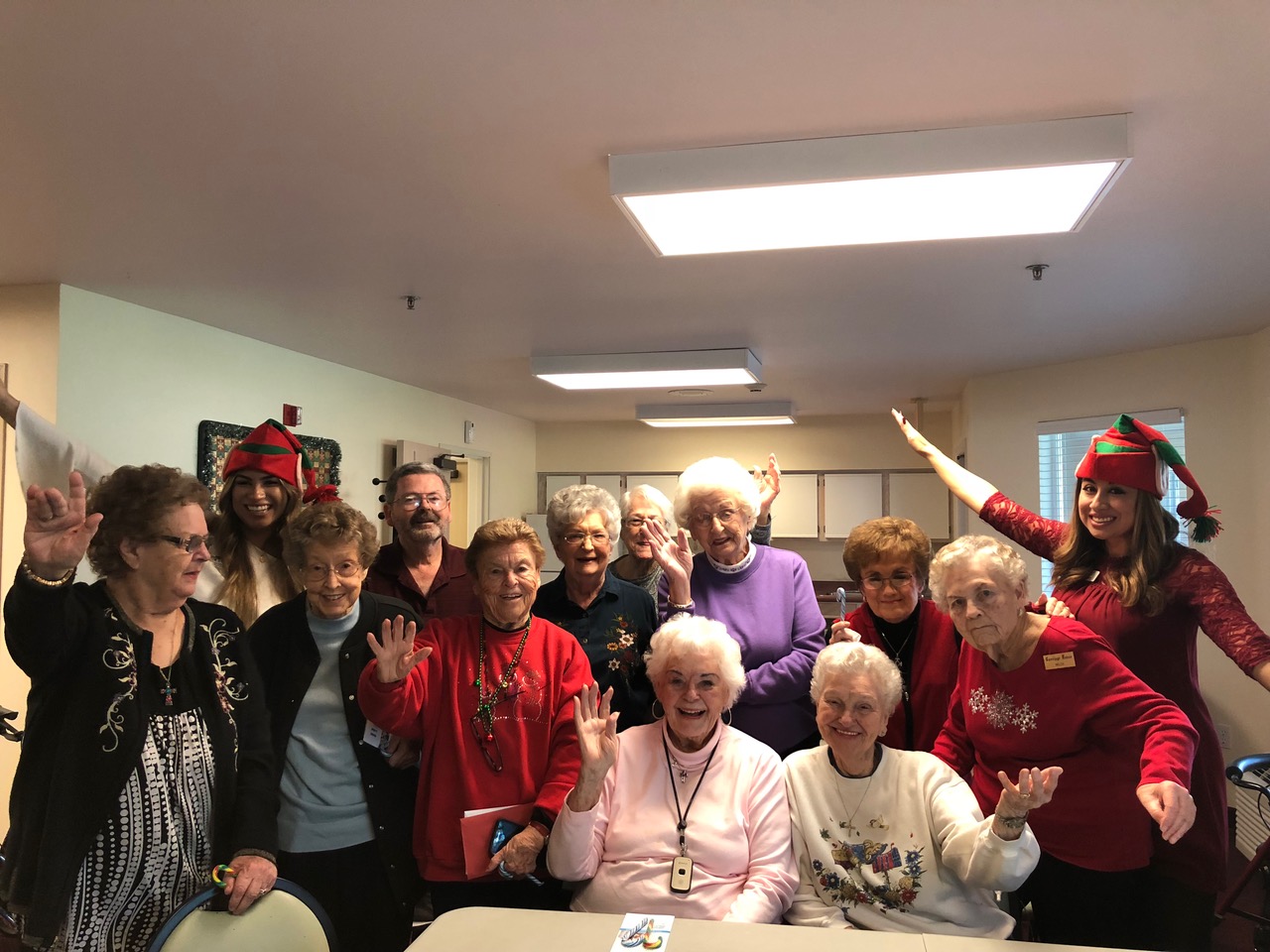 group of older women waving at camera